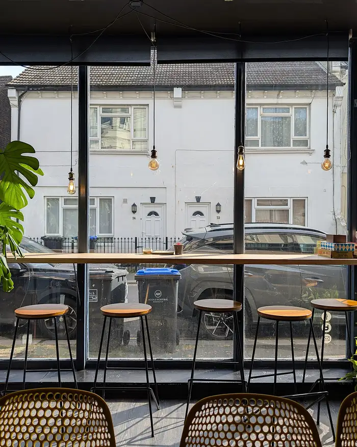 A bright cafe with tables by a large window
